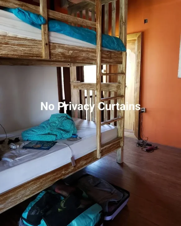 Bunk beds without privacy curtains at a hostel in Bali
