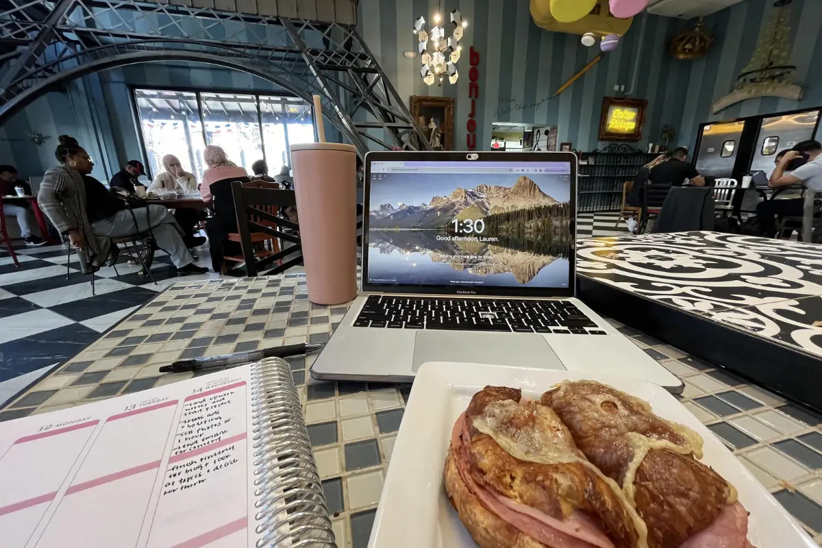 Photo of a digital nomad setup at Amelie's French Bakery and Cafe in NODA Charlotte, with one of their Croque Monsieur sandwich