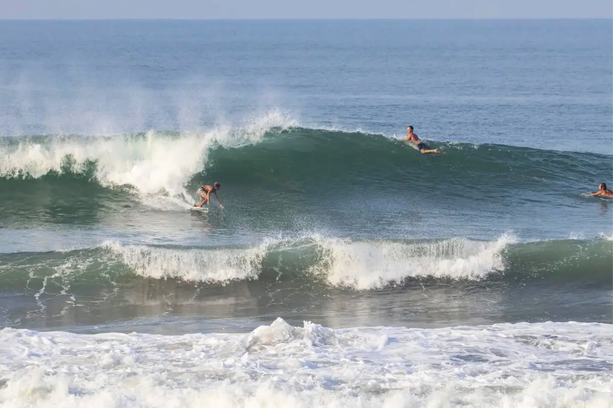 Surfers surfing at Canggu Beach