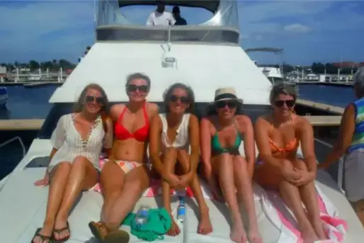 Lauren Edmondson of Inspired Backpacker and friends on a boat in the Grand Cayman