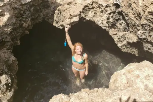 Lauren Edmondsn standing at opening of Mermaid Caves in Waikiki Hawaii
