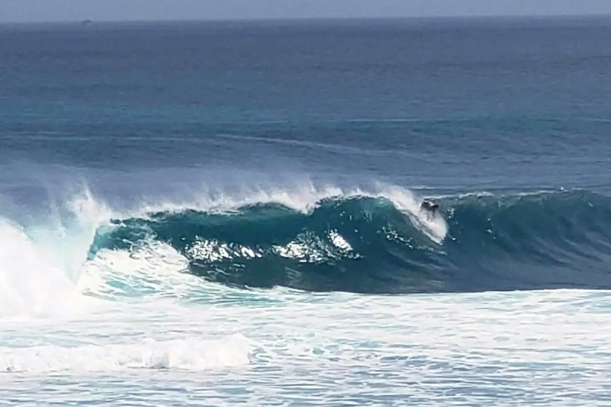 Big wave surfer at Suluban Beach in Uluwatu Bali