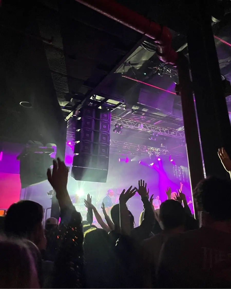 Live music show at the Fillmore Charlotte, with people in the air and enjoying the show