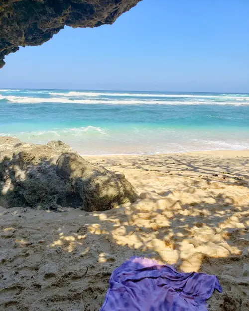 Beach towel and hangout spot in one of the caves at Green Bowl beach, which is one of the lesser known Uluwatu beaches