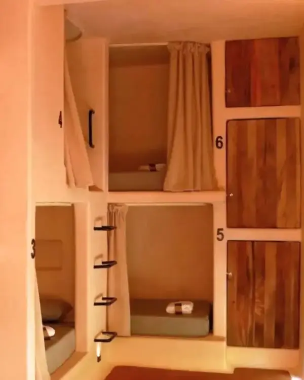 Dorm at Secret Beach Hostel, showing how the pod-style beds have curtains and are very nice