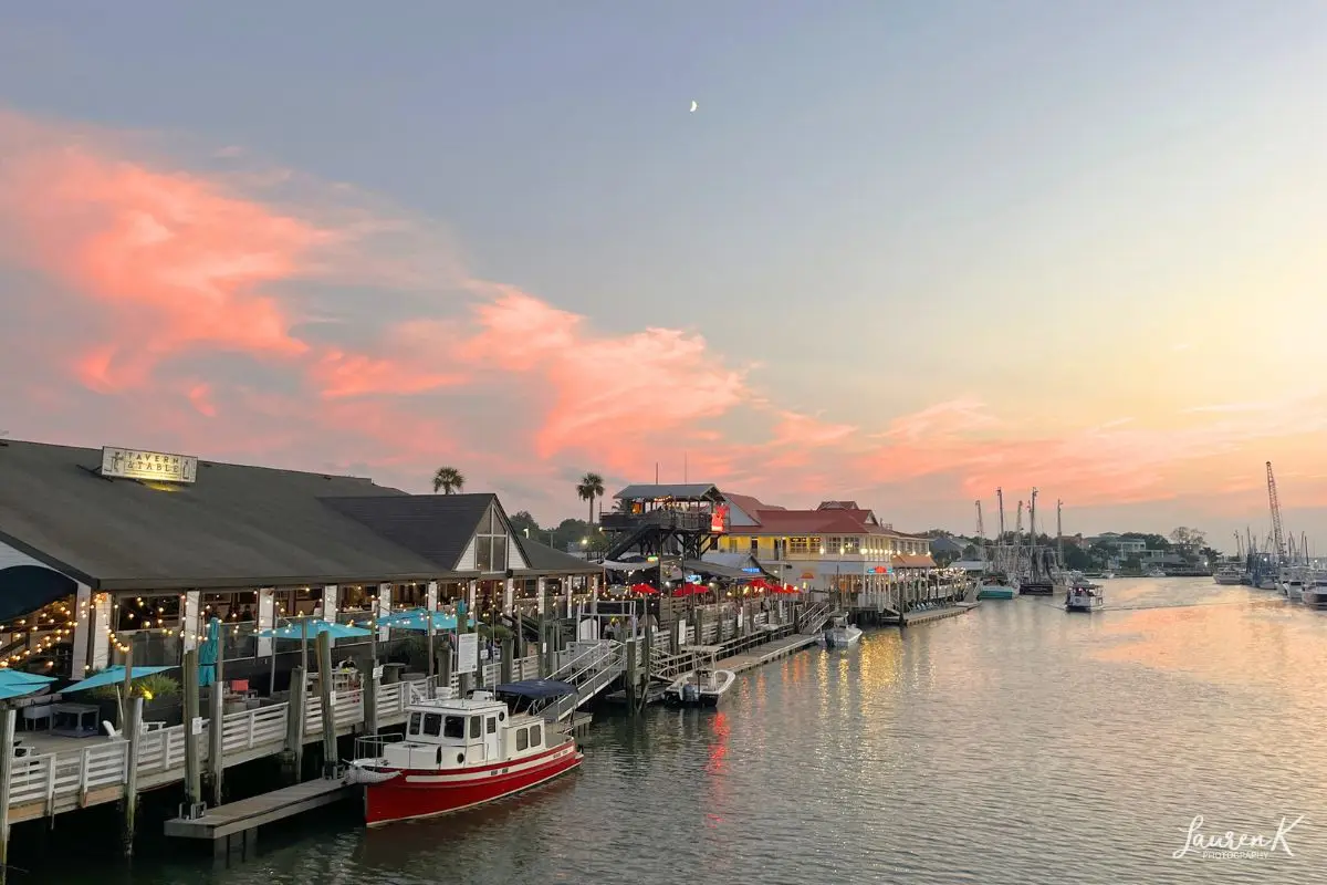 Cover image for the where to stay in charleston blog post which shows Shems Creek boardwalk at sunset