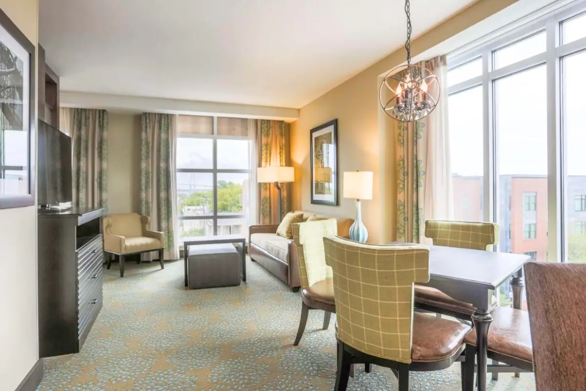 Bright suite at the Homewood Suites Historic District hotel by Hilton, showing a living room and dining room area