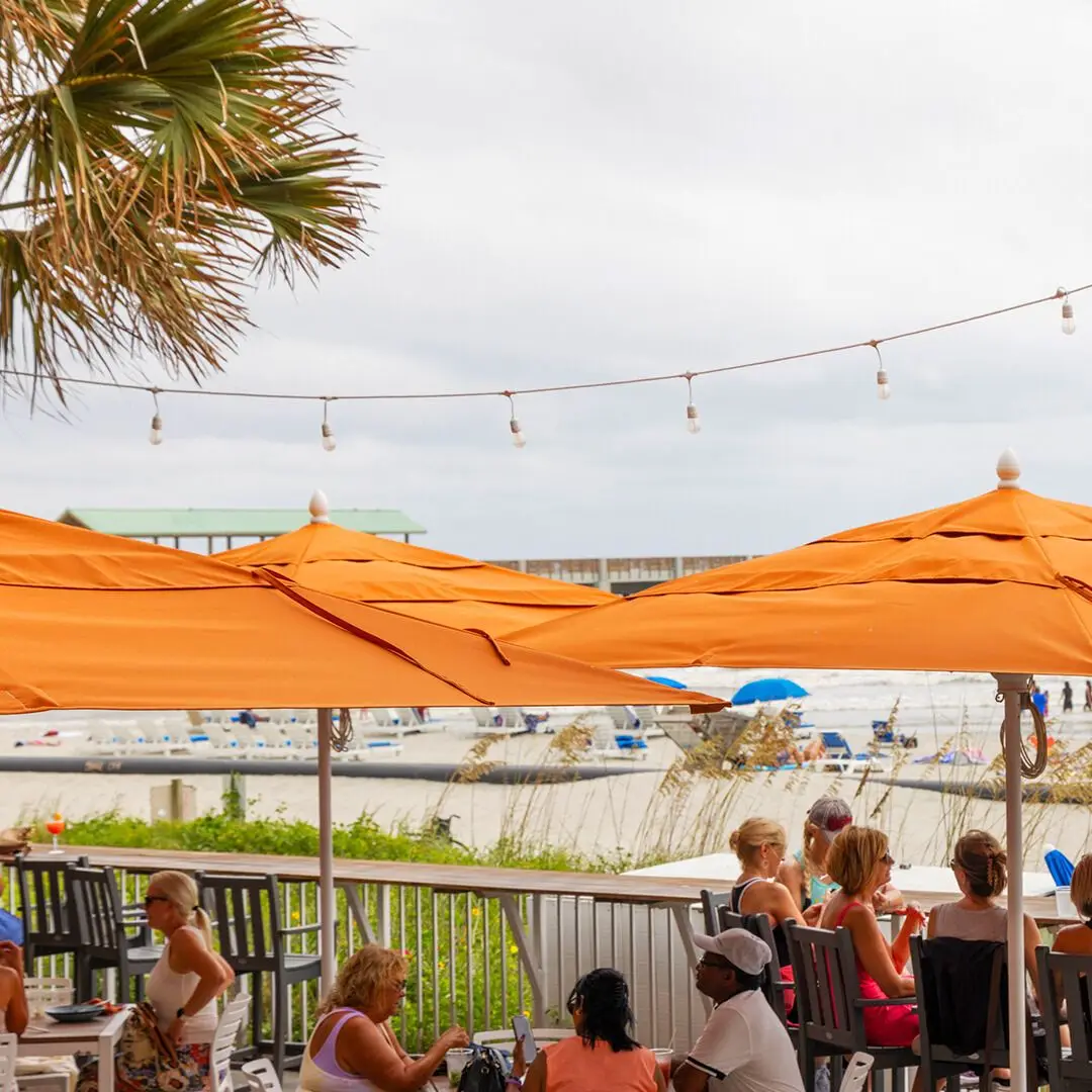 The patio overlooking the ocean at BLU beachfront bar and grill, showing that it's one of the best places for brunch in Folly Beach SC