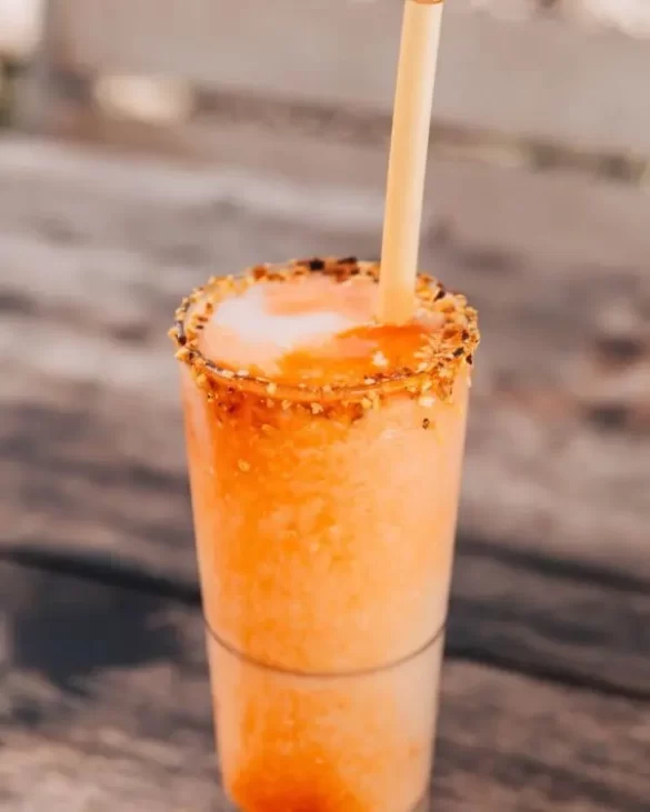 A tall frozen Bloody Mary cocktail with old bay around the rim