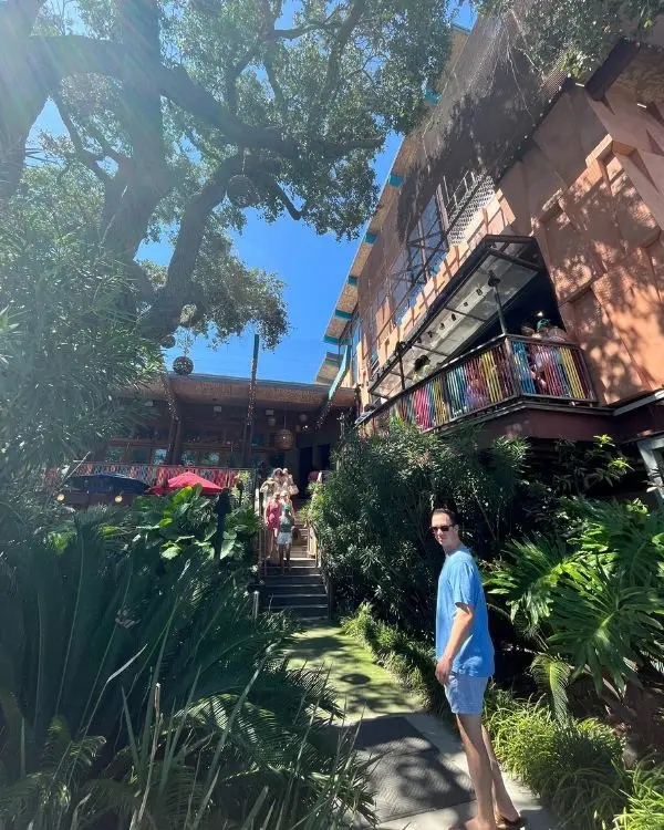 The exterior of Taco Boy Folly Beach underneath giant trees with an gorgeous elevated indoor outdoor patio