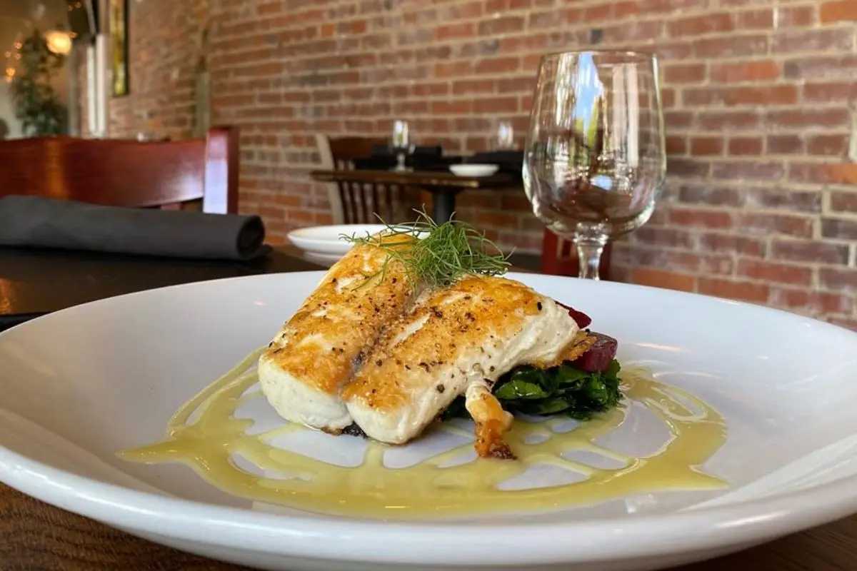An entree on the table with a brick lined wall behind it at Local Chop & Grill House