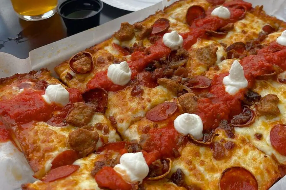 Detroit style pizza with globs of cheese and sauce on top at Pale Fire Brewing Co