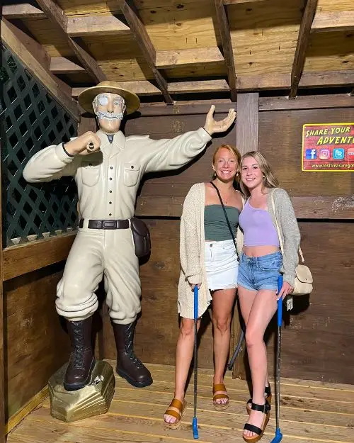 A current photo of my sister and I at Lost Treasure with the Professor statue many years later