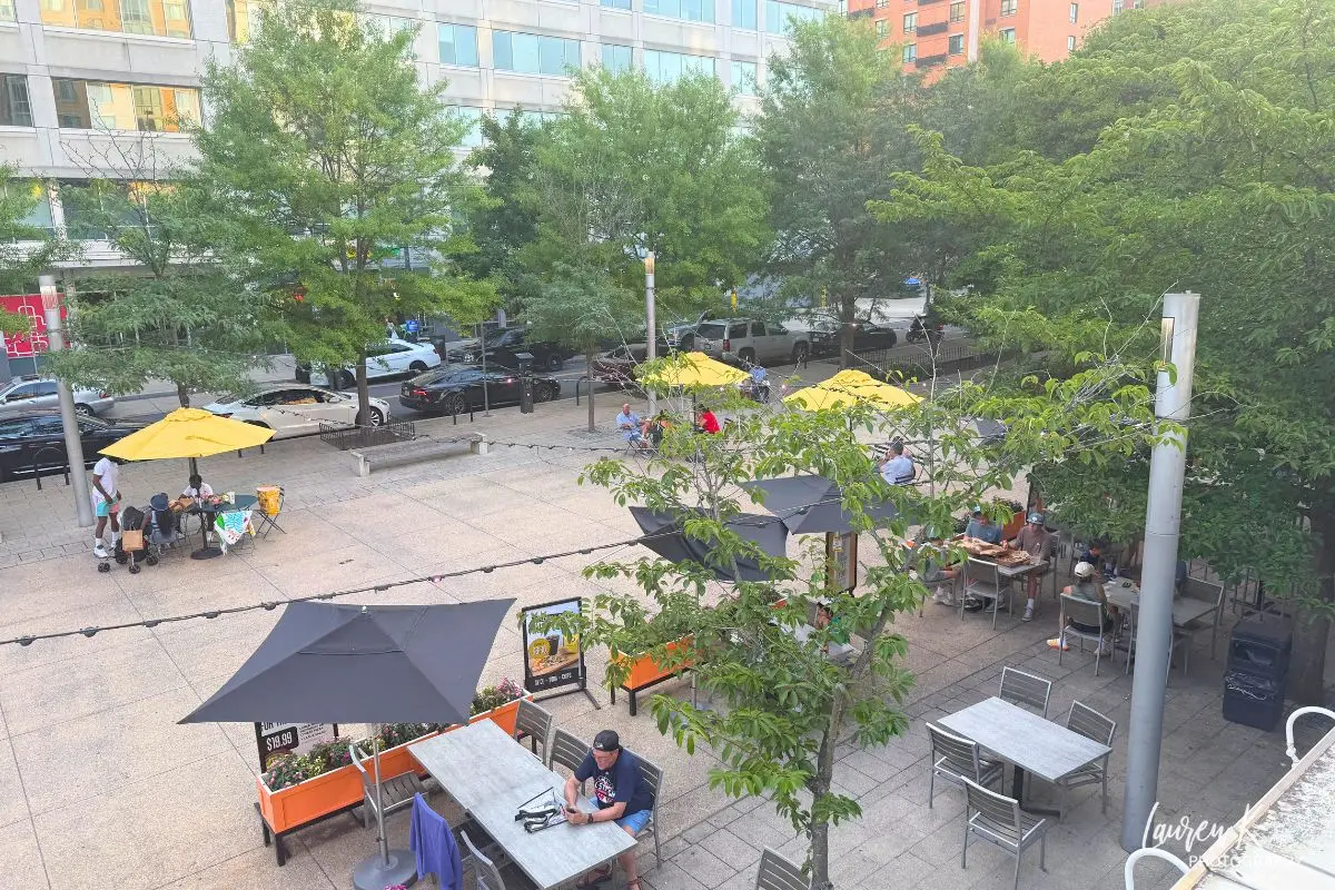 An aerial view of the patio and chairs at the Canal Park, where people are eating and relaxing outdoors