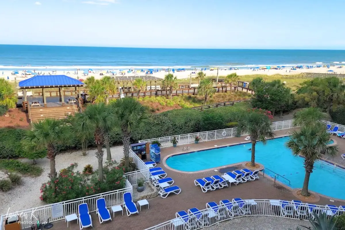 The oceanfront pool with the beach in the background at the Courtyard Marriott on Carolina Beach, to show it's one of the best beaches in North Carolina for family vacations