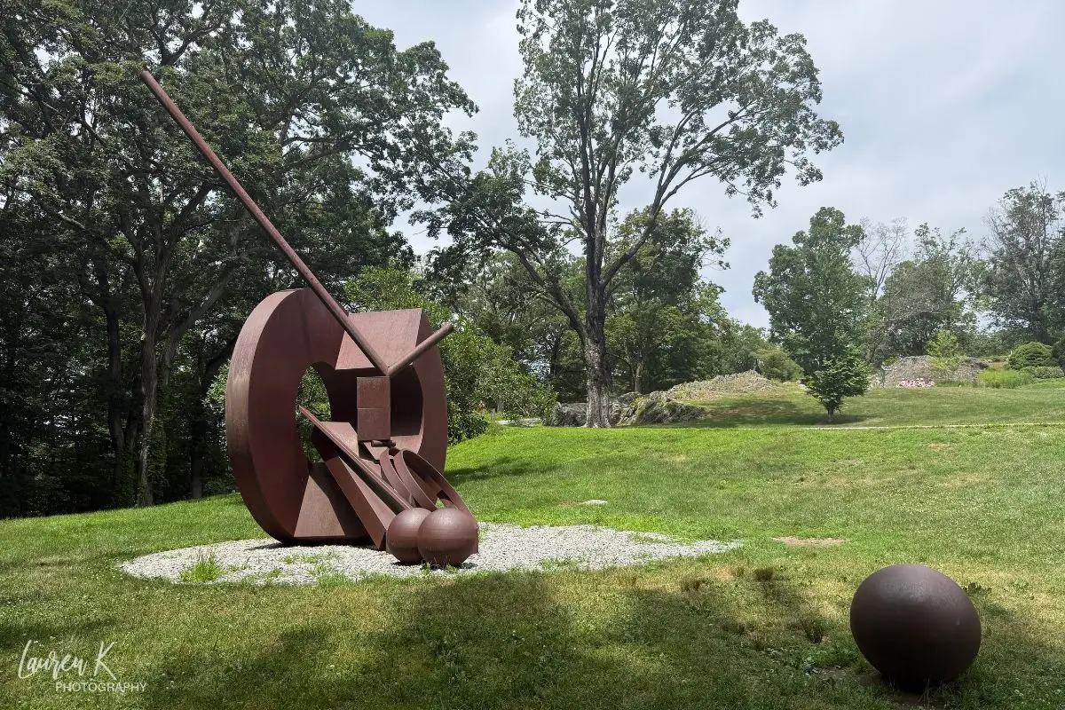 A big metal sculpture in a field, showing a sample of what to expect at the DeCordova Sculpture Park and Museum