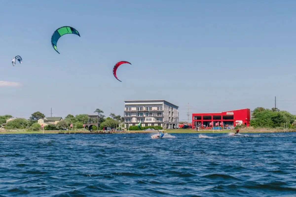 An image of people kiteboarding on the sound at Cape Hatteras, showing that this is the best choice for where to stay in Outer Banks NC for water sports