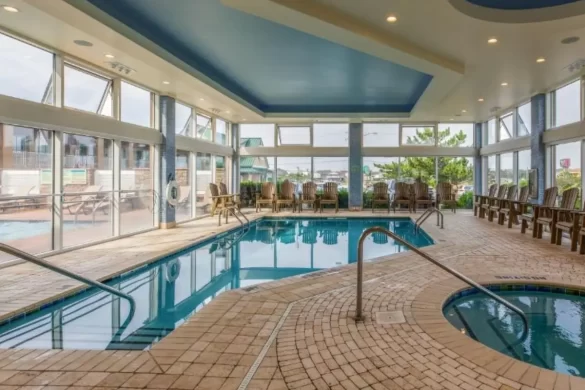 The indoor pool and hot tub with floor to ceiling windows at Shutters on the Banks