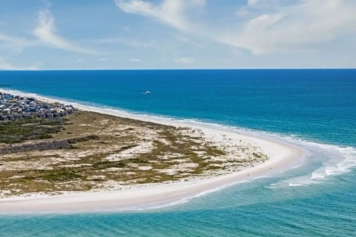 An aerial view of Topsail Beach with blue water and white sand