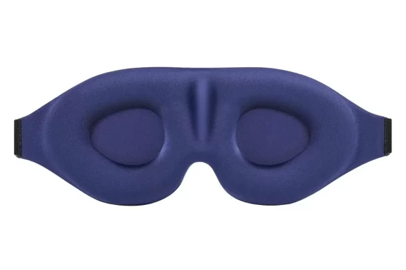 A blue cushioned face mask that can be used for better sleep on long travel days