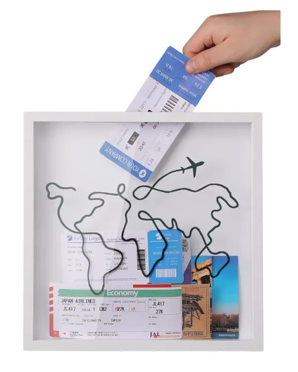 One of the most unique gifts for travel lovers, a shadow box with the outline of an abstract map of the world on top, where people can drop things from their travels into to display memories