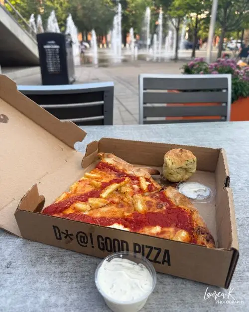 A slice of Parmesan Chicken pizza and garlic knots 