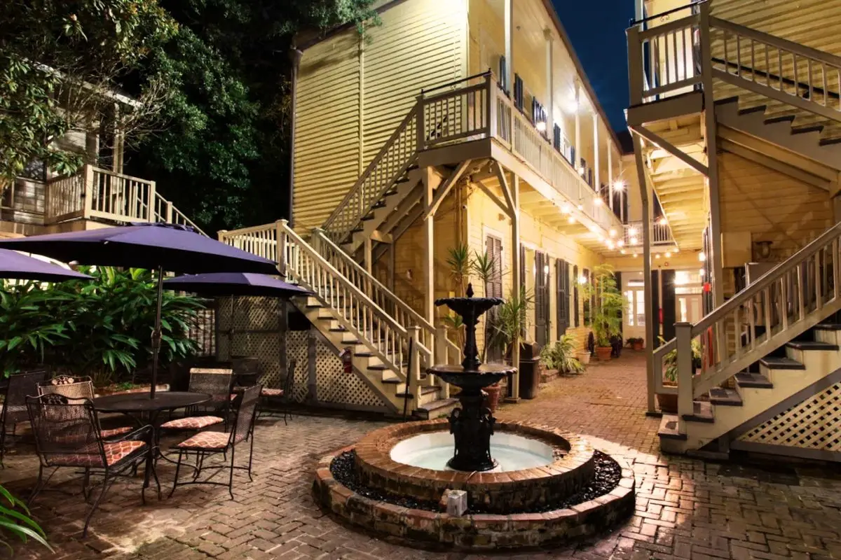 A New Orleans style courtyard at the Andrew Jackson hotel and inn, with a fountain at nighttime, to show that New Orleans is definitely one of the best Halloween travel destinations