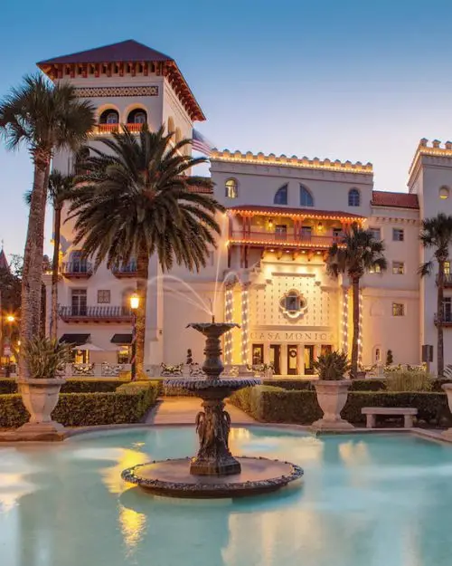 The beautiful Casa Monica resort and spa exterior and fountain. This type of hotel is common in St. Augustine and part of what makes it one of the best beach towns in Florida