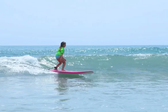 A girl surfing a small wave