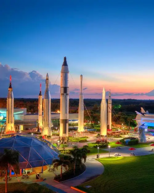 The Kennedy Space Center lit up during sunset, to show that Cocoa Beach is the best of the beach towns in Florida for anyone interested in outer space