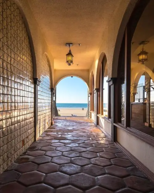 A shaded arched, stone walkway to the ocean at the historic La Jolla Shores hotel 