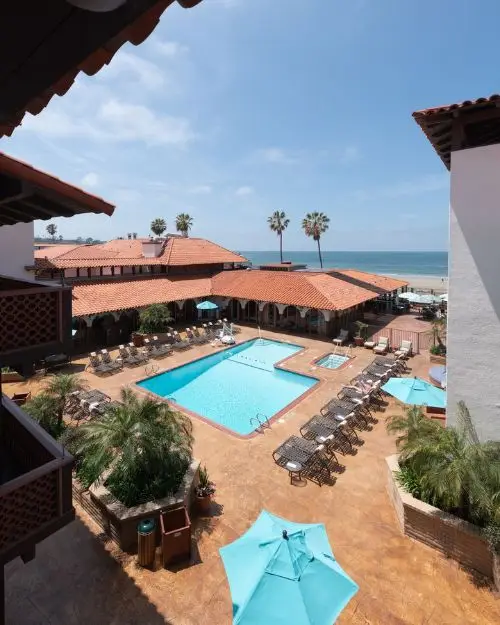 The boardwalk front pool with lounge chairs at the La Jolla Shores hotel on a sunny day