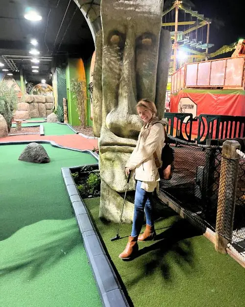 Me posing with my golf club at the mini golf at Belmont Park