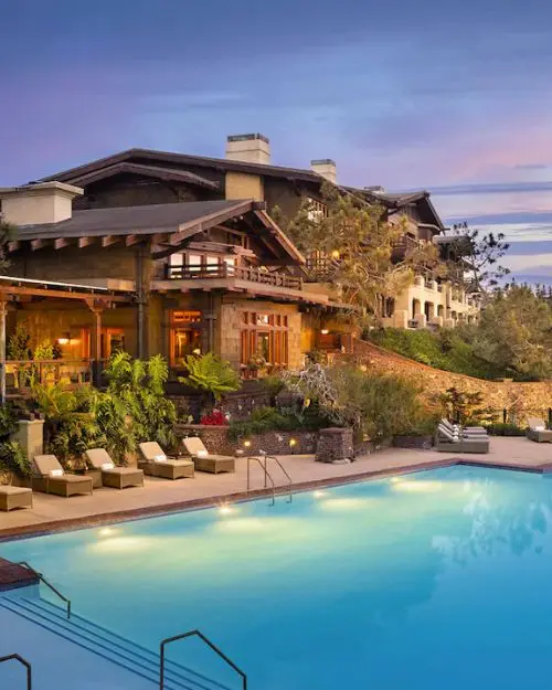 The exotic looking Lodge at Torrey Pines above the luxurious pool with lounge chairs at dusk