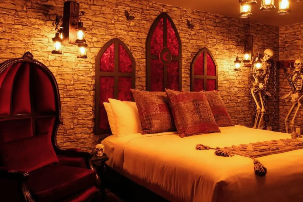 A dungeon, vampire themed room with brick walls and red decor at the Cove at Salem hotel