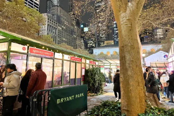 Cover image for the best places to travel in December blog showing the Bryant Park holiday market in NYC