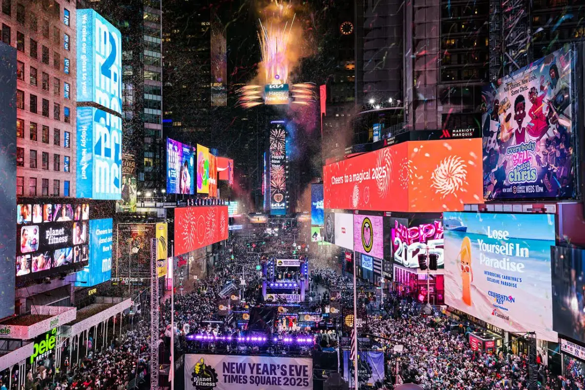 A packed Times Square during the New Year's Eve bash lit up with snow falling
