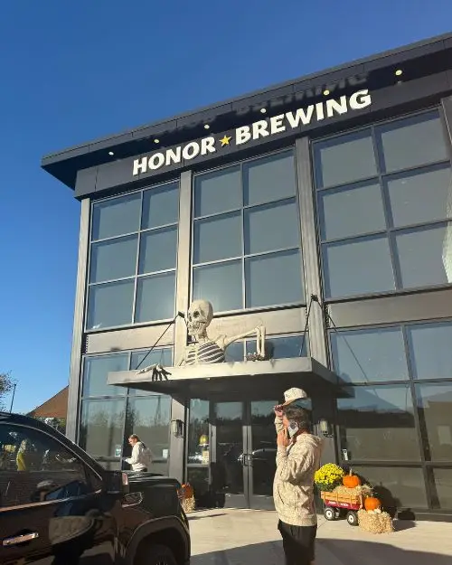 The exterior of Honor Brewing with a giant skeleton over the entrance