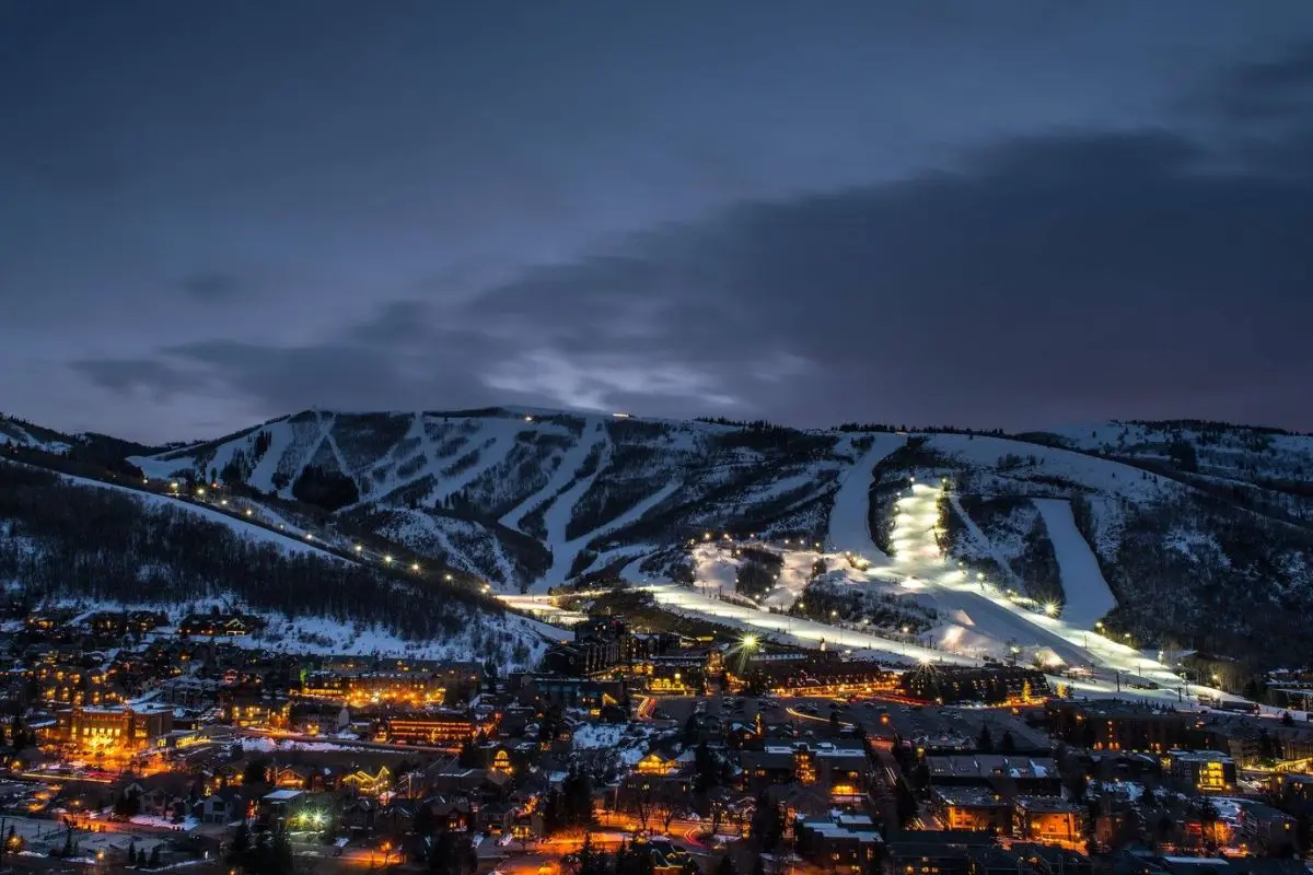 A magical aerial view of Park City lit up at night with snow on the mountains