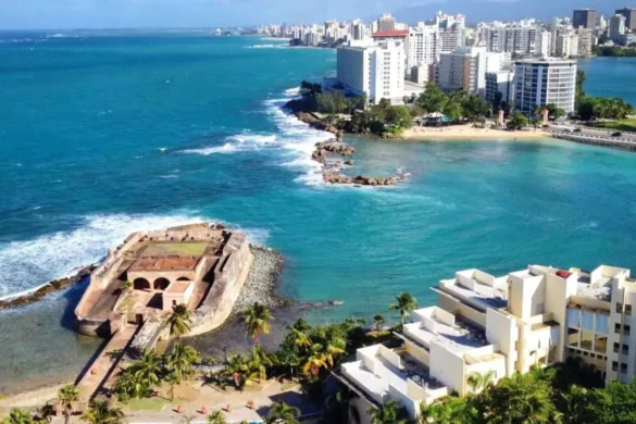 An aerial view of a fort and the city of San Juan on a sunny day with a crystal blue ocean, to show how picturesque of a destination it is