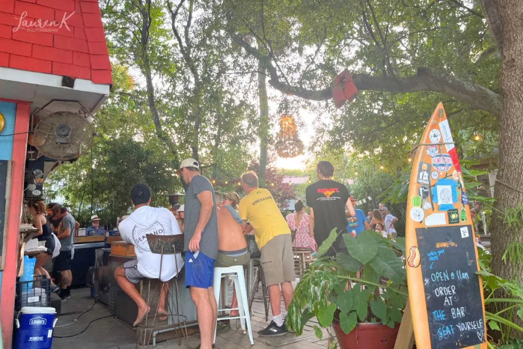 Bars in Folly Beach SC cover image which shows Chico Feo, a casual popular bar under the trees