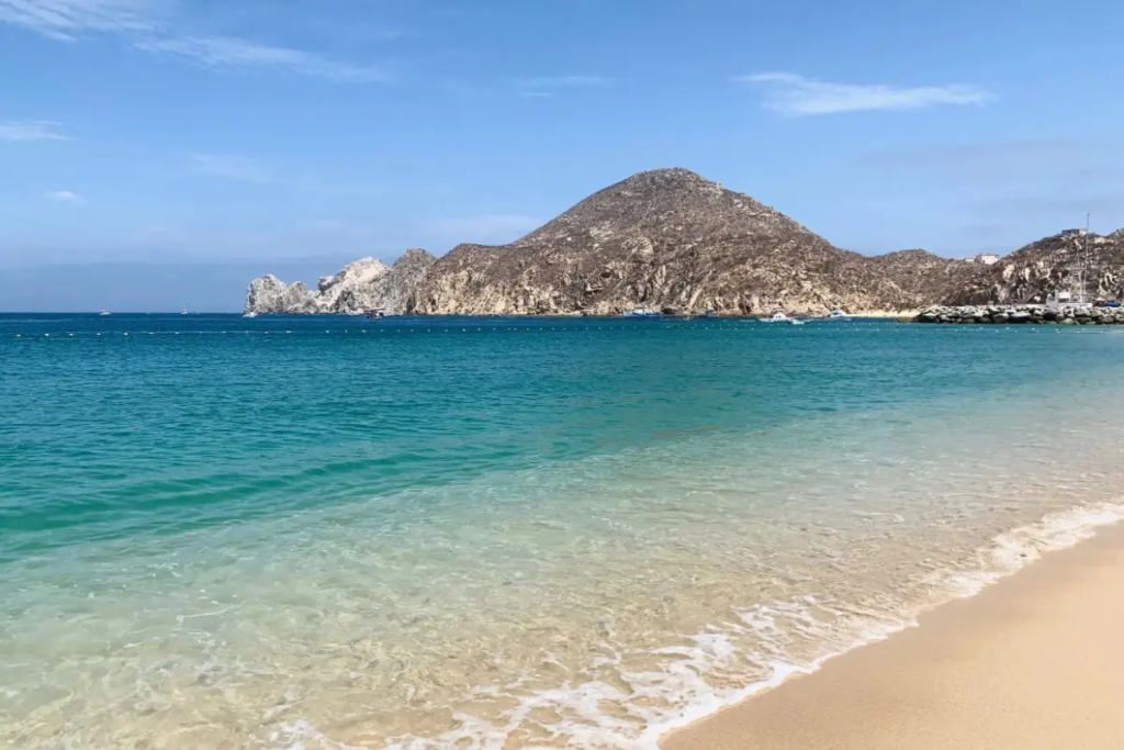 Cover image for the Cabo San Lucas digital nomad travel guide which shows a mountain off in the distance and the ocean