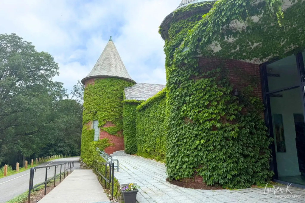 Cover image for the DeCordova Sculpture Park and Museum review which shows the moss covered museum exterior