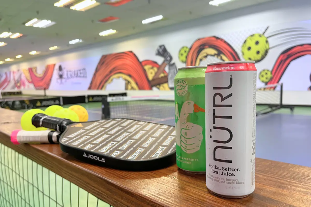 Kraken pickleball review blog post cover image of a paddle board with two drinks