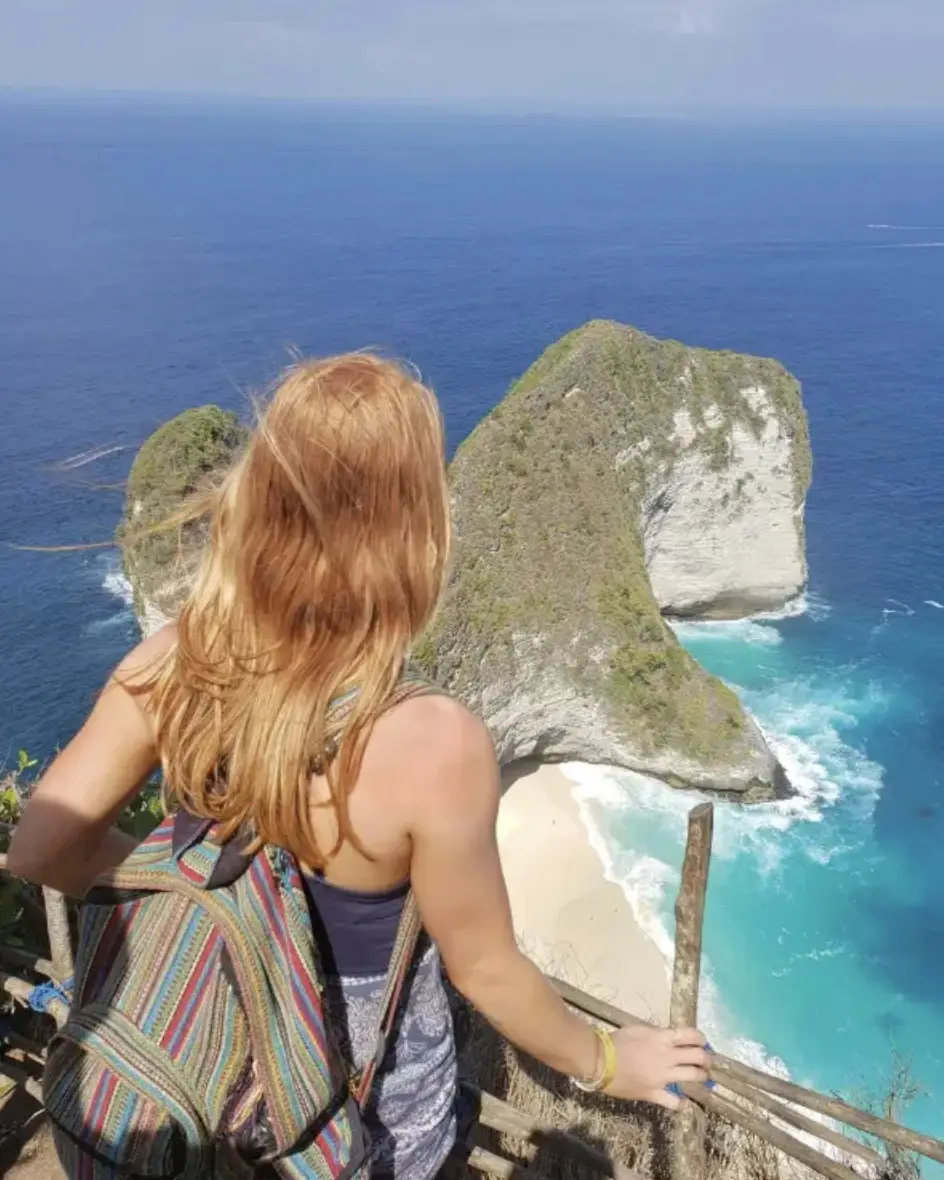 Photo of a solo traveler looking out over KelingKing Beach, to demonstrate independence