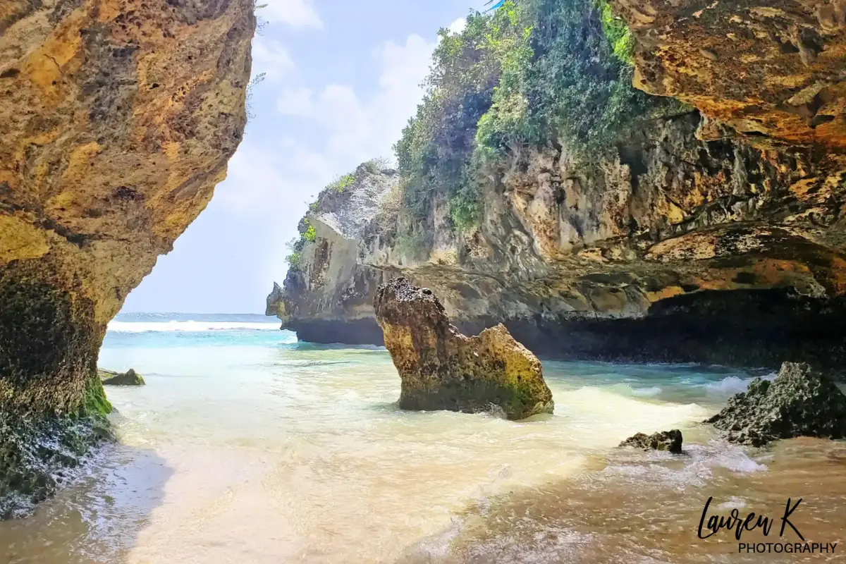 The limestone caves and rock formations at an empty Suluban Beach, with the tide rising
