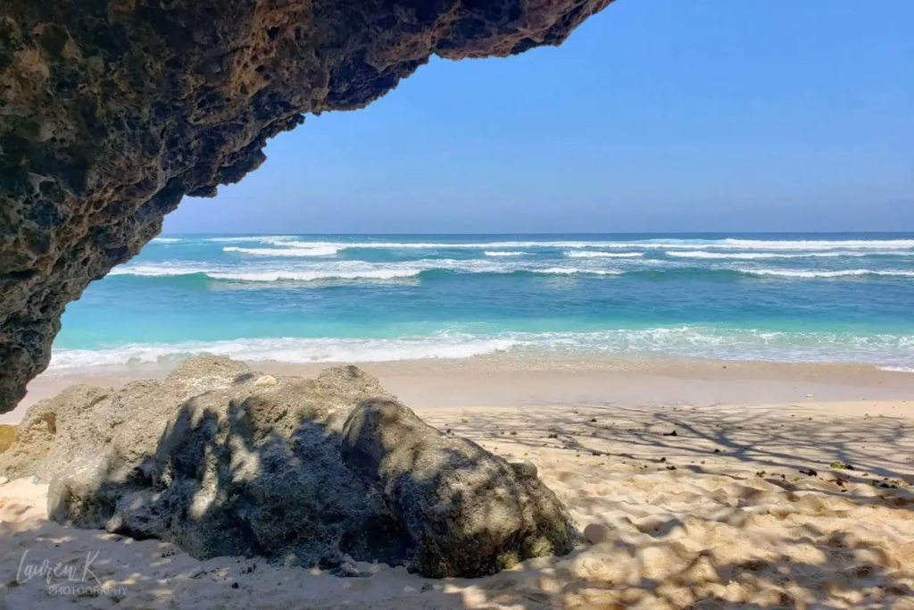 Cover image for the Uluwatu Beaches blog which shows a cave and the beautiful ocean at Green Bowl Beach